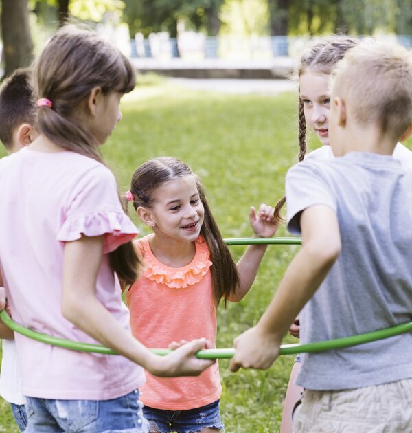 medium_shot_best_friends_playing_with_hula_hoop